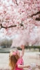 📱桜を見上げる外国人の女の子 Galaxy A53 5G 壁紙・待ち受け