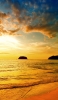 📱青空 夕暮れ時の海 遠くに見える島 iPhone 13 mini 壁紙・待ち受け