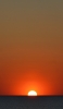 📱沈む夕日と穏やかな海 iPhone 11 Pro 壁紙・待ち受け