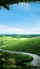 📱澄んだ空と緑の丘陵地帯 iPhone SE (第3世代) 壁紙・待ち受け