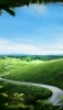 📱澄んだ空と緑の丘陵地帯 iPhone SE (第2世代) 壁紙・待ち受け