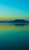 📱エメラルドグリーンの空と海と遠くに見える島 iPhone 6s 壁紙・待ち受け