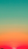 📱緑とオレンジのグラデーションの空 夕日 Galaxy A32 5G 壁紙・待ち受け